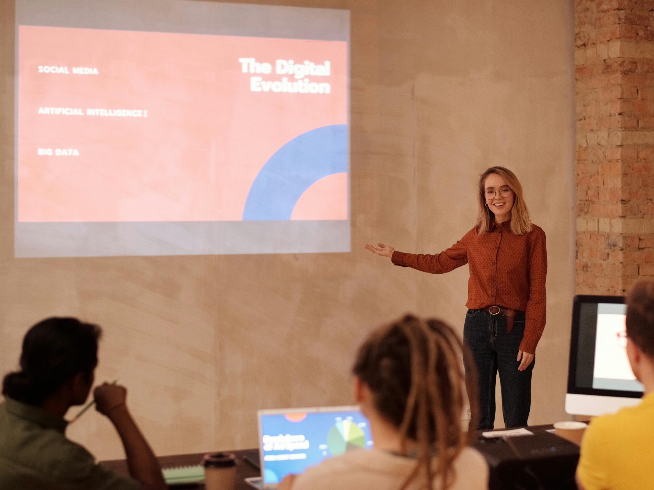 Professional Woman presenting a slide show to a group of co-workers.